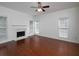 Living room with fireplace, hardwood floors, and large windows providing natural light at 2158 Berryhill Se Cir, Smyrna, GA 30082