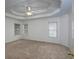 Spacious main bedroom features a tray ceiling with ceiling fan and plush carpeting at 2158 Berryhill Se Cir, Smyrna, GA 30082
