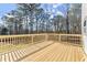 New wooden deck with railing overlooking a lush backyard and scenic wooded area at 3170 Old Hwy 92 Dr, Acworth, GA 30102