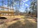 Spacious backyard featuring a wooden deck overlooking the lawn and mature trees at 3170 Old Hwy 92 Dr, Acworth, GA 30102