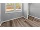 Bright bedroom featuring wood-look flooring, neutral gray walls, and a large window at 3170 Old Hwy 92 Dr, Acworth, GA 30102