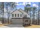 Charming two-story home featuring stone accents and a gray garage door with a large concrete driveway at 3170 Old Hwy 92 Dr, Acworth, GA 30102