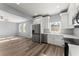 Open concept living room and kitchen with stainless steel appliances and hardwood floors at 3170 Old Hwy 92 Dr, Acworth, GA 30102
