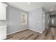 Bright room featuring wood-look flooring, neutral gray walls, a large window, and white trim at 3170 Old Hwy 92 Dr, Acworth, GA 30102