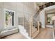 Bright entryway features a staircase with light wood steps, black iron spindles, and a bench near a window at 2587 Apple Valley Rd, Brookhaven, GA 30319