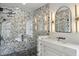 Modern walk-in shower featuring rainfall shower head, glass enclosure, and beautiful herringbone tile work at 2587 Apple Valley Rd, Brookhaven, GA 30319