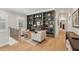 Cozy sitting area with built-in bookshelves and cabinets, providing an elegant and functional space at 2587 Apple Valley Rd, Brookhaven, GA 30319