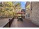 Wooden deck with a patio table set, perfect for enjoying outdoor dining and relaxing in a backyard setting at 1415 Swiftwater Cir, Mcdonough, GA 30252
