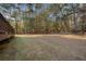 Large backyard with seating area and view from the deck with wooded area at 1415 Swiftwater Cir, Mcdonough, GA 30252