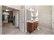 Bright bathroom with vanity, sleek mirror, and stylish fixtures, leading to a luxurious bedroom at 1415 Swiftwater Cir, Mcdonough, GA 30252