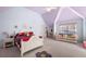 Charming bedroom with unique ceiling design, cozy sofa, and a decorative flower rug at 1415 Swiftwater Cir, Mcdonough, GA 30252