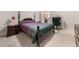 Bedroom featuring a bed, nightstand with lamp, and a desk area, offering comfort and functionality at 1415 Swiftwater Cir, Mcdonough, GA 30252