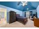 Blue themed bedroom with unique starry ceiling design, adding a playful and creative touch to the space at 1415 Swiftwater Cir, Mcdonough, GA 30252