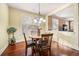 Cozy dining area with hardwood floors, a wood table, and views into the adjacent living spaces at 1415 Swiftwater Cir, Mcdonough, GA 30252