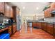 Open kitchen with granite countertops, stainless steel appliances, wooden cabinetry, and hardwood floors at 1415 Swiftwater Cir, Mcdonough, GA 30252