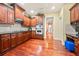 This kitchen features wooden cabinets, stainless steel appliances, and hardwood floors at 1415 Swiftwater Cir, Mcdonough, GA 30252