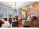 Comfortable living room featuring hardwood floors, a chandelier, and ample seating for relaxation at 1415 Swiftwater Cir, Mcdonough, GA 30252