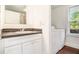 Bathroom featuring a vanity with a sink, mirror, and a washer and dryer unit at 5520 Glore Sw Dr, Mableton, GA 30126