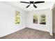 Cozy bedroom featuring neutral carpet, white walls, and two large windows offering natural light at 5520 Glore Sw Dr, Mableton, GA 30126