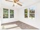 Bright bedroom featuring neutral carpet, white walls, large windows, and a ceiling fan at 5520 Glore Sw Dr, Mableton, GA 30126