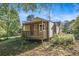Charming home with a covered porch and rustic siding, nestled among mature trees at 5520 Glore Sw Dr, Mableton, GA 30126