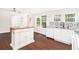 Spacious, bright kitchen with an island, new floors, white walls and appliances, with abundant natural light at 5520 Glore Sw Dr, Mableton, GA 30126