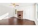 Bright living room features new floors, white walls, fireplace with brick surround, and abundant natural light at 5520 Glore Sw Dr, Mableton, GA 30126