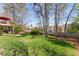 Spacious backyard featuring a lush lawn, mature trees, and a two-story deck, perfect for outdoor living at 960 Whitehawk Trl, Lawrenceville, GA 30043