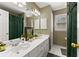 Well-lit bathroom with double sink vanity, striped wallpaper, and modern fixtures at 960 Whitehawk Trl, Lawrenceville, GA 30043