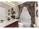 Well-maintained bathroom with combination tub and shower, vanity with sink and decorative accents at 960 Whitehawk Trl, Lawrenceville, GA 30043