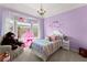 Bright bedroom featuring a bay window, chandelier, and charming decor at 960 Whitehawk Trl, Lawrenceville, GA 30043