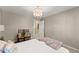 Neutral bedroom featuring a bench, beige walls, and carpeted flooring at 960 Whitehawk Trl, Lawrenceville, GA 30043