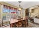 Bright dining room with hardwood floors, a rustic chandelier, and open views to the living room at 960 Whitehawk Trl, Lawrenceville, GA 30043