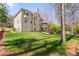 A view of the back of the house from the grassy backyard and featuring a two-story deck at 960 Whitehawk Trl, Lawrenceville, GA 30043