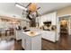 Spacious kitchen featuring white cabinets, hardwood floors, a center island, and an eat-in breakfast area at 960 Whitehawk Trl, Lawrenceville, GA 30043