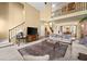 Open concept living room with high ceilings, neutral carpet, and views of the dining area and stairway at 960 Whitehawk Trl, Lawrenceville, GA 30043