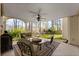 Covered patio with neutral furniture and a ceiling fan overlooking a manicured lawn and mature trees at 960 Whitehawk Trl, Lawrenceville, GA 30043