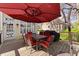 Lovely outdoor deck with wood floors, a red umbrella, and a dining table with chairs at 960 Whitehawk Trl, Lawrenceville, GA 30043