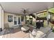Covered patio featuring comfortable seating, a ceiling fan, and access to the backyard and upper deck at 960 Whitehawk Trl, Lawrenceville, GA 30043