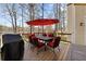 Spacious outdoor deck with wood floors, a grill, and a dining table with chairs at 960 Whitehawk Trl, Lawrenceville, GA 30043