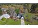 Aerial view of home highlighting its charming facade, well-manicured lawn, and mature trees at 115 Dearing Woods Way, Covington, GA 30014