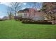 Grassy backyard has well-kept lawn, mature trees, and a charming deck for outdoor enjoyment and entertaining at 115 Dearing Woods Way, Covington, GA 30014