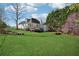 Expansive backyard features a well-maintained lawn and mature trees, offering a private outdoor oasis at 115 Dearing Woods Way, Covington, GA 30014