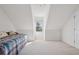 Attic bedroom featuring vaulted ceilings, light carpet, and a comfortable daybed at 115 Dearing Woods Way, Covington, GA 30014