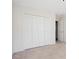Bedroom with light-colored carpet and a large closet at 115 Dearing Woods Way, Covington, GA 30014
