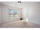 Spacious bedroom with light-colored carpet and a bright window at 115 Dearing Woods Way, Covington, GA 30014