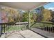 View from a covered deck overlooking the spacious, lush backyard with mature trees and landscaping at 115 Dearing Woods Way, Covington, GA 30014
