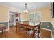Traditional dining room with wood floors and a large table adjacent to a spacious living room at 115 Dearing Woods Way, Covington, GA 30014