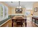 Traditional dining room with wood floors, a large table, and natural light from the many windows at 115 Dearing Woods Way, Covington, GA 30014