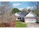 Charming single-story home with brick accents, lush lawn, and attached two-car garage at 115 Dearing Woods Way, Covington, GA 30014
